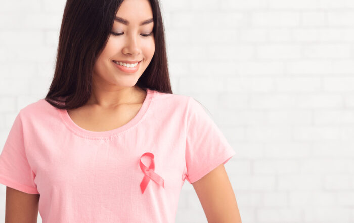 young woman with breast cancer wearing pink