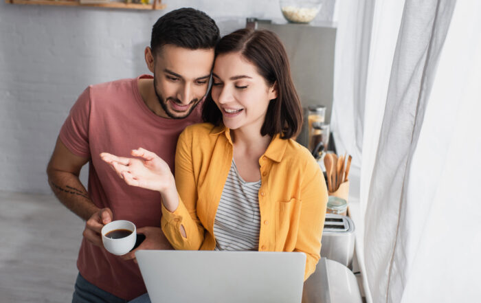 couple looking at fertility benefits on computer