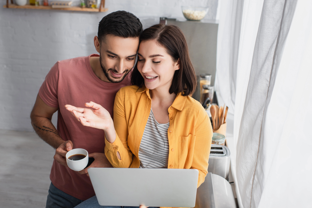 fertility benefits couple looking at fertility benefits on computer